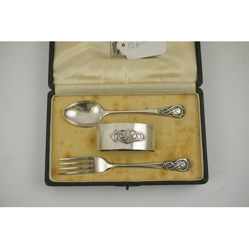 53 - A 1930's Arts & Crafts Liberty & Co cased silver three piece christening set, comprising a spoon, fo... 