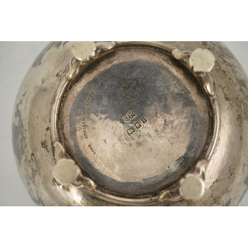 54 - A George V Arts & Crafts silver shallow bowl, by Omar Ramsden, of circular form, on four scroll and ... 