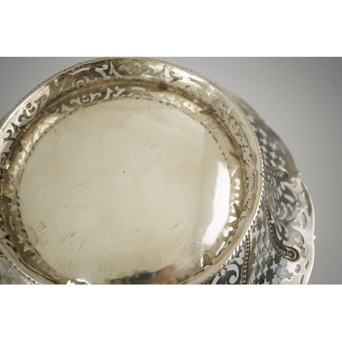 6 - A late George II pierced silver cake basket, by William Plummer?, of shaped circular form, with engr... 