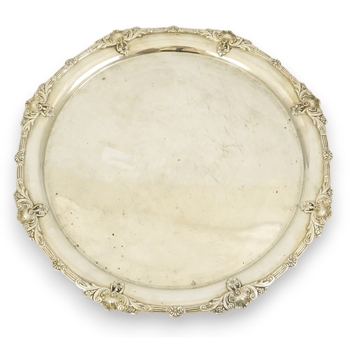 60 - A George VI silver salver by Goldsmiths & Silversmiths Co Ltd, with reeded and shell border, on four... 