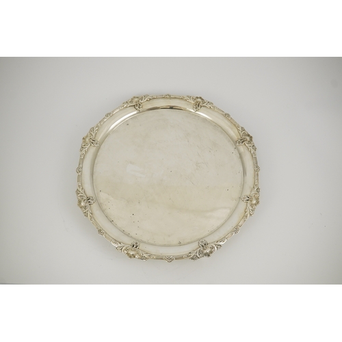 60 - A George VI silver salver by Goldsmiths & Silversmiths Co Ltd, with reeded and shell border, on four... 