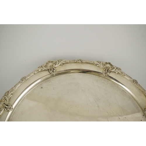 60 - A George VI silver salver by Goldsmiths & Silversmiths Co Ltd, with reeded and shell border, on four... 