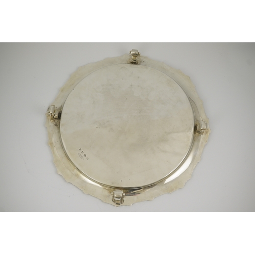 60 - A George VI silver salver by Goldsmiths & Silversmiths Co Ltd, with reeded and shell border, on four... 