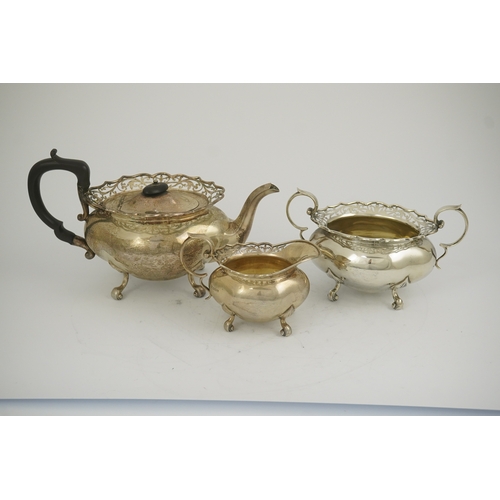 63 - A George V three piece silver circular tea set by James Deakin & Sons, with pierced borders, Sheffie... 