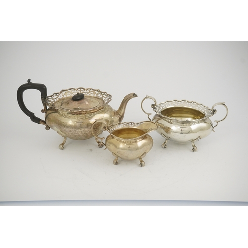 63 - A George V three piece silver circular tea set by James Deakin & Sons, with pierced borders, Sheffie... 