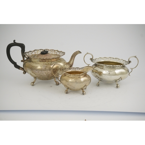 63 - A George V three piece silver circular tea set by James Deakin & Sons, with pierced borders, Sheffie... 