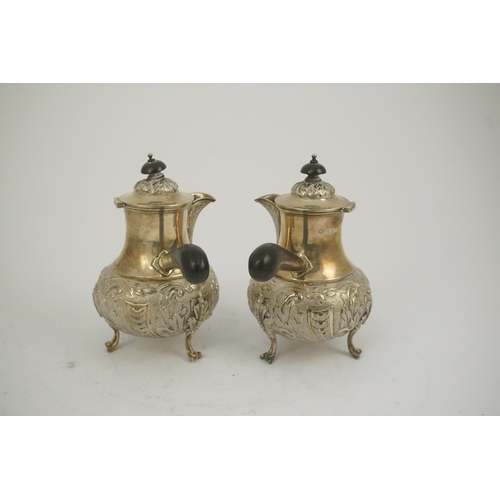 64 - A pair of George V silver chocolate pots, by Goldsmiths & Silversmiths Co Ltd, of baluster form and ... 