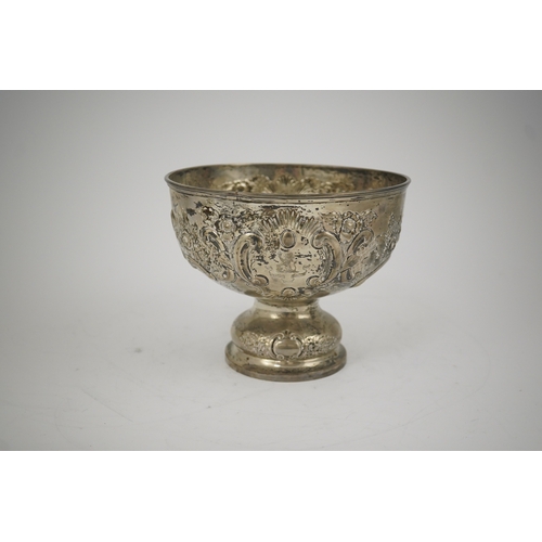 65 - A George V repousse silver pedestal rose bowl, by Carrington & Co, decorated with foliate scrolls an... 