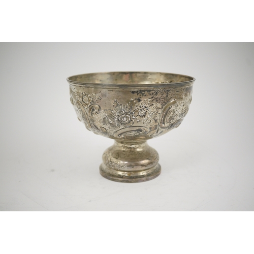 65 - A George V repousse silver pedestal rose bowl, by Carrington & Co, decorated with foliate scrolls an... 