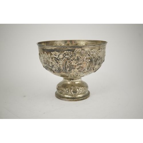 65 - A George V repousse silver pedestal rose bowl, by Carrington & Co, decorated with foliate scrolls an... 