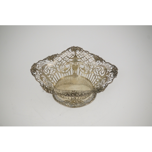 67 - A George V pierced silver oval bowl, by James Dixon & Sons, with scroll decoration and wavy fruiting... 