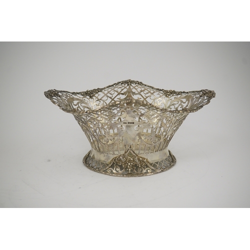 67 - A George V pierced silver oval bowl, by James Dixon & Sons, with scroll decoration and wavy fruiting... 