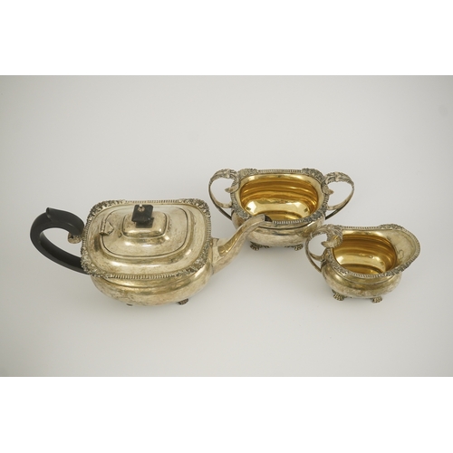 77 - A George V silver three piece tea set by Edward Barnard & Sons Ltd, of oval form, with gadrooned and... 