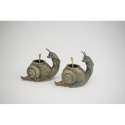 79 - A pair of Elizabeth II novelty cast silver salts and spoons, by Garrard & Co, modelled as snails, wi... 