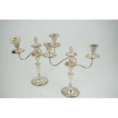 86 - A modern pair of silver two branch three light oval candelabra, by James Dixon and Sons Ltd, with re... 