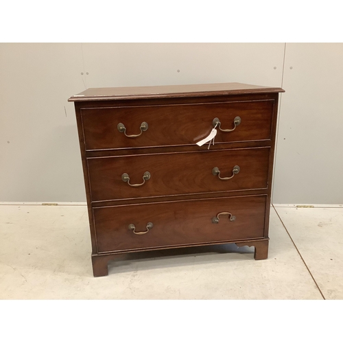 1012 - An early 20th century mahogany chest with a moulded top, three long drawers with brass loop handles ... 