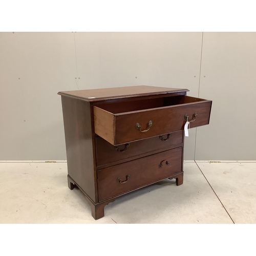 1012 - An early 20th century mahogany chest with a moulded top, three long drawers with brass loop handles ... 