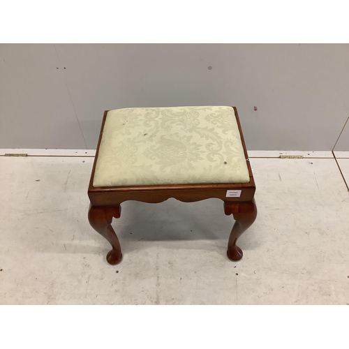 1016 - A Queen Anne style walnut dressing stool, with shaped frieze and cabriole legs, the drop in seat cov... 