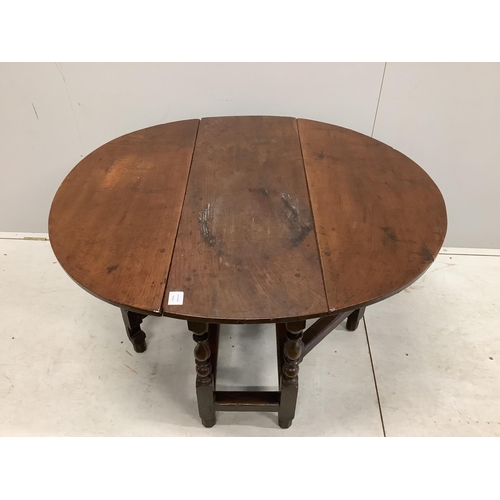 1017 - An 18th century oak gateleg table with an oval top on baluster turned under frame, 112cm extended, d... 