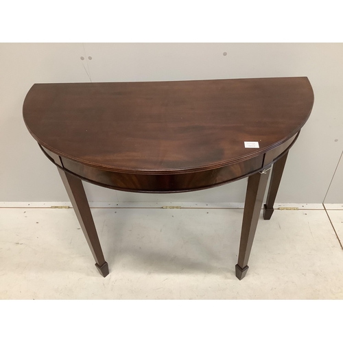 1033 - A George III style mahogany demi-lune console table on tapered legs and spade feet, width 114cm, dep... 