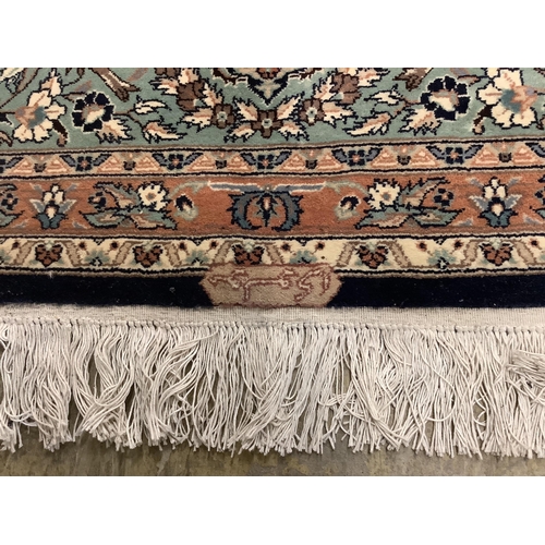 1054 - An Isfahan design blue ground rug, 330 x 250cm. Condition - good