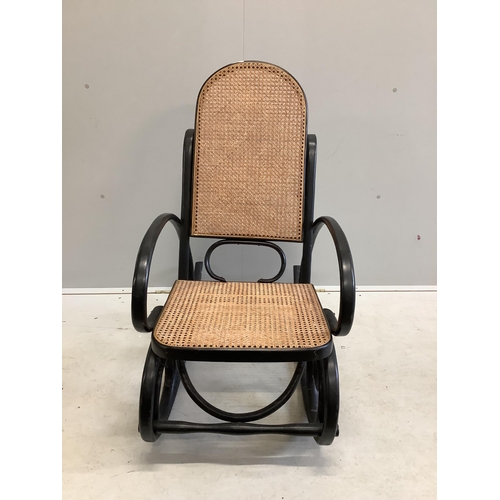 1077 - An early 20th century ebonised caned bentwood rocking chair, possibly Thonet, width 53cm, depth 100c... 