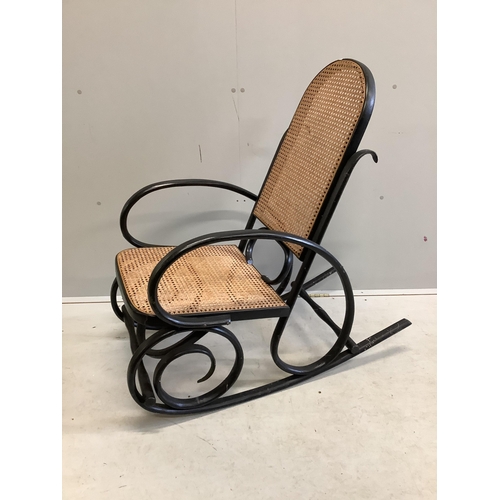 1077 - An early 20th century ebonised caned bentwood rocking chair, possibly Thonet, width 53cm, depth 100c... 