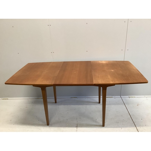 1082 - A mid century teak extending dining table, 174cm extended, one spare leaf, depth 83cm, height 74cm. ... 