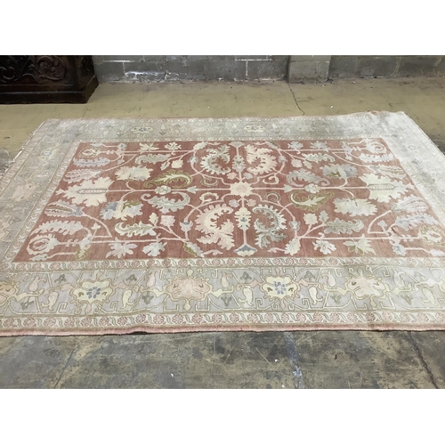 1101 - A Zeigler style pale red ground carpet, 340 x 250cm. Condition - fair