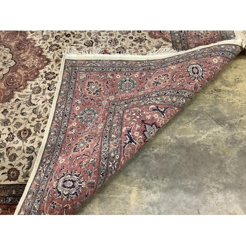 1106 - An Isfahan design ivory ground rug, approximately 340 x 246cm. Condition - good