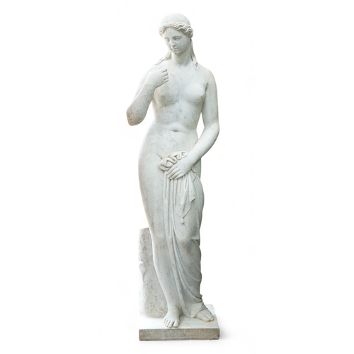 1160 - After the Antique. A large 19th century reconstituted marble figure of Venus, standing beside a tree... 