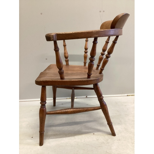 1163 - A Victorian elm and beech smoker's bow elbow chair on slender turned baluster legs with H stretcher,... 