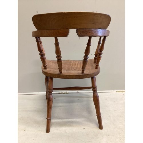 1163 - A Victorian elm and beech smoker's bow elbow chair on slender turned baluster legs with H stretcher,... 