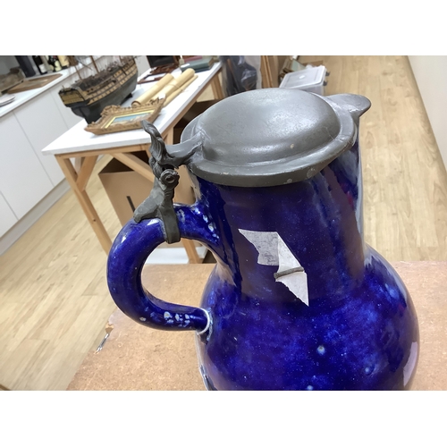 1268 - An 18th century German blue glazed faience jug with pewter lid, 30cm. Condition - poor to fair... 