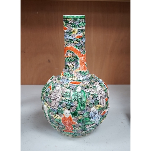 1277 - A Chinese moulded and reticulated porcelain eighteen luohan bottle vase, early 20th century, 34cm hi... 