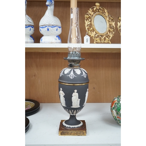 1278 - A Victorian black jasper oil lamp and reservoir, 65cm high. Condition - repaired at stem