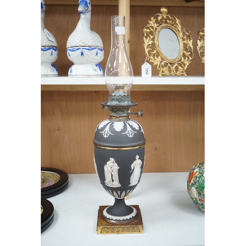 1278 - A Victorian black jasper oil lamp and reservoir, 65cm high. Condition - repaired at stem