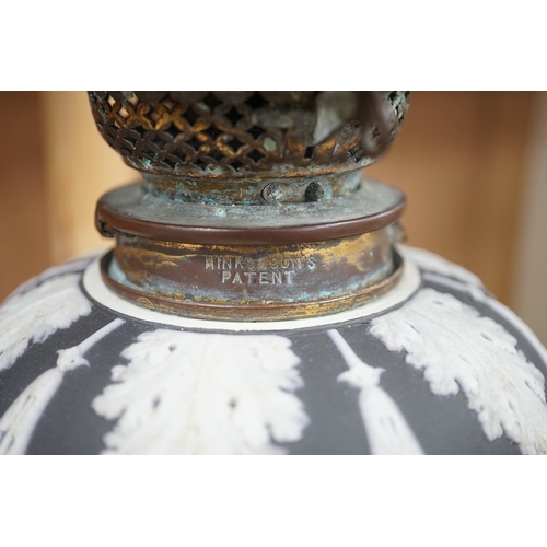 1278 - A Victorian black jasper oil lamp and reservoir, 65cm high. Condition - repaired at stem