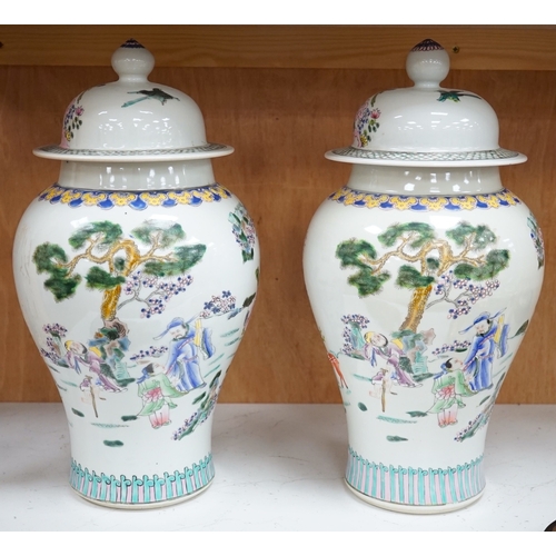 1281 - A pair of Chinese famille rose baluster vases and covers, 44cm high. Condition - good