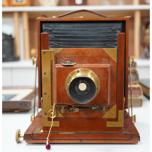 1291 - A late 19th/early 20th century brass and mahogany half plate bellows camera with a lens and a shutte... 