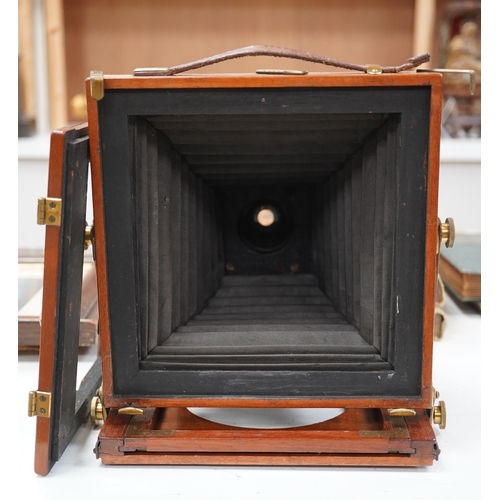 1291 - A late 19th/early 20th century brass and mahogany half plate bellows camera with a lens and a shutte... 