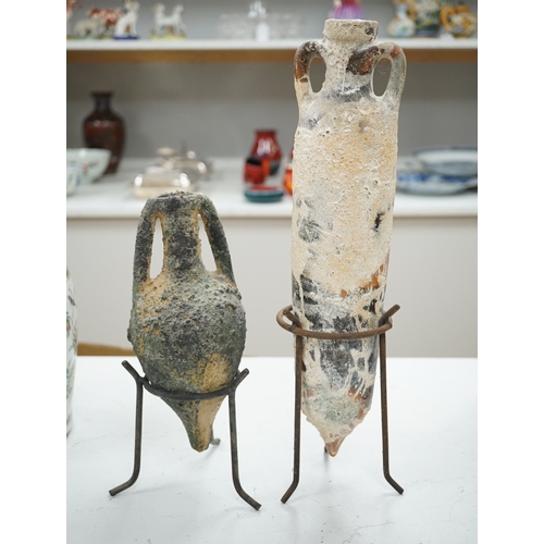 1299 - Two pottery amphora on metal stands, tallest 43cm high. Condition - as on line images