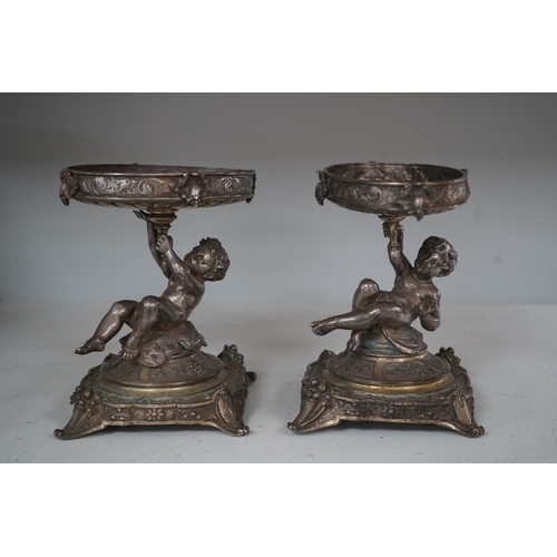 1304 - A pair of early 20th century Elkington & Co. silver plated putti stands, 17cm. Condition - fair to... 