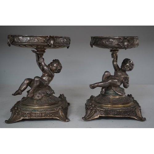 1304 - A pair of early 20th century Elkington & Co. silver plated putti stands, 17cm. Condition - fair to... 