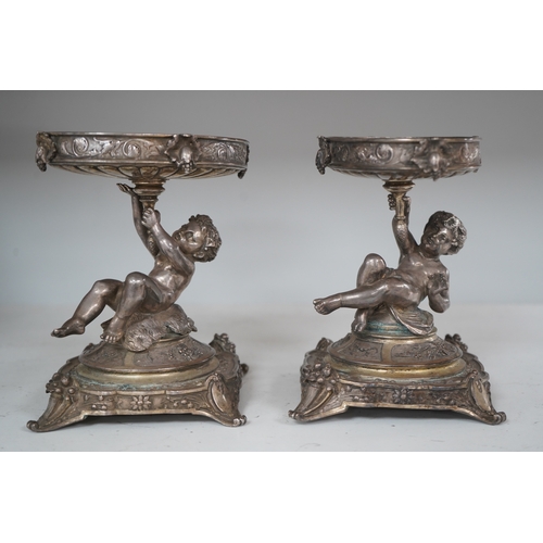 1304 - A pair of early 20th century Elkington & Co. silver plated putti stands, 17cm. Condition - fair to... 