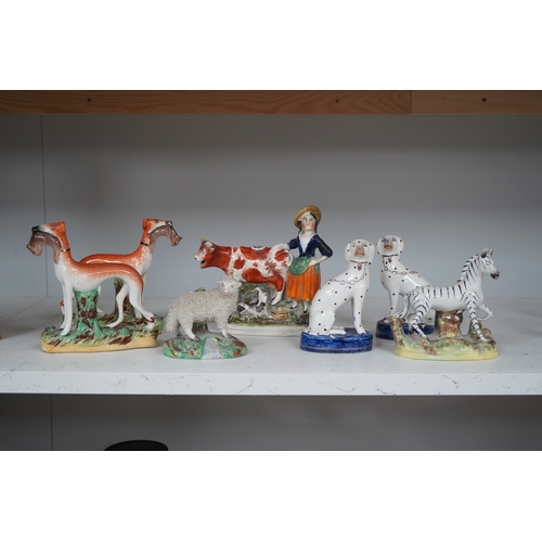 1308 - Eight Staffordshire figures to include a pair of Dalmatians and a cow creamer figure, largest 18cm ... 