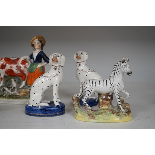 1308 - Eight Staffordshire figures to include a pair of Dalmatians and a cow creamer figure, largest 18cm ... 