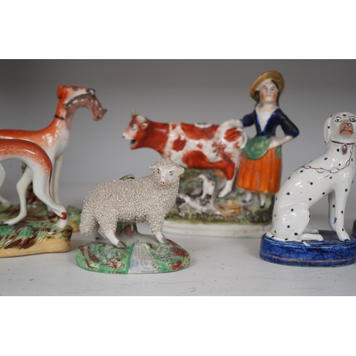 1308 - Eight Staffordshire figures to include a pair of Dalmatians and a cow creamer figure, largest 18cm ... 