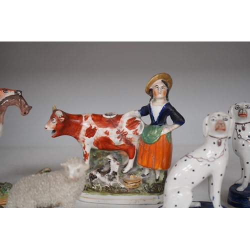 1308 - Eight Staffordshire figures to include a pair of Dalmatians and a cow creamer figure, largest 18cm ... 