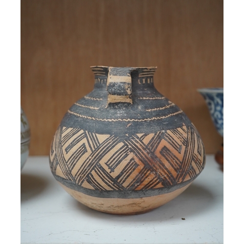 1362 - A Chinese neolithic pottery two handled jar - 14cm tallProvenance: the vendors parents lived in Hon... 